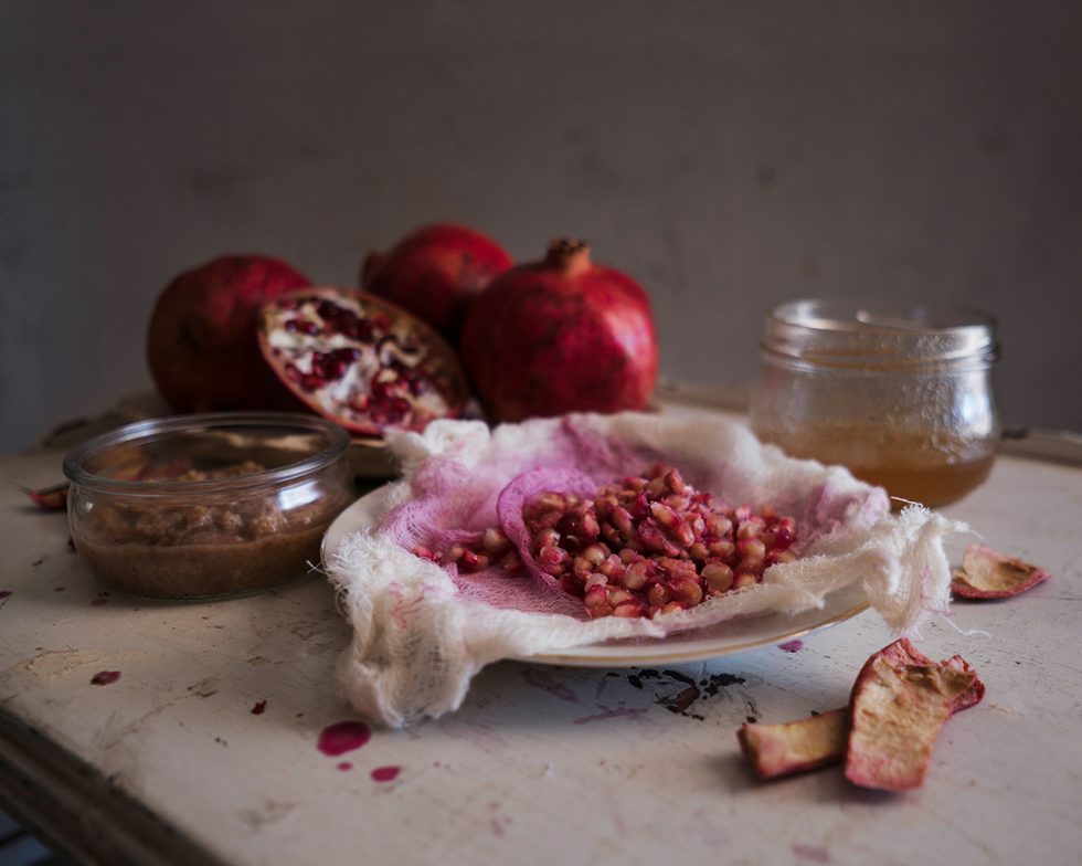 Amanda Mollindo's photography of medicine series with open pomegranates an strained juice.