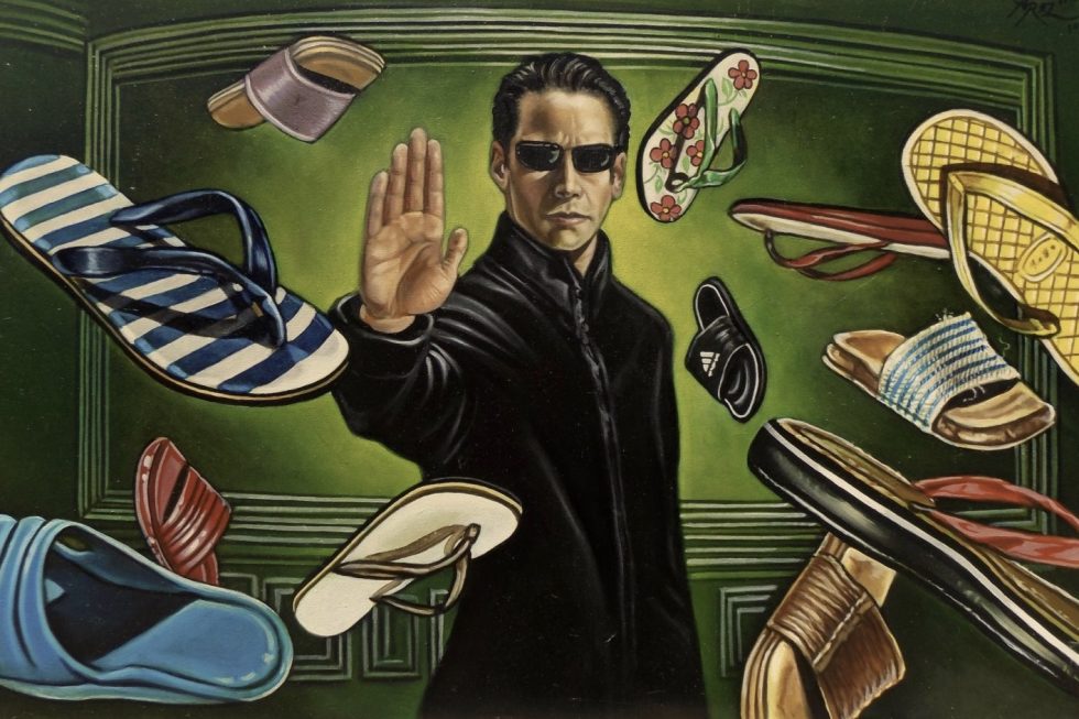 Neo from The Matrix stops sandals from flying his direction by placing his hand up in a stop hand signal.
